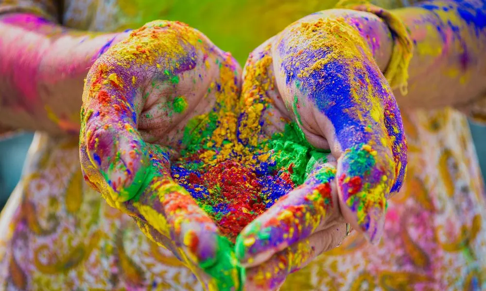 Person's Hand Full Of Colored Powder