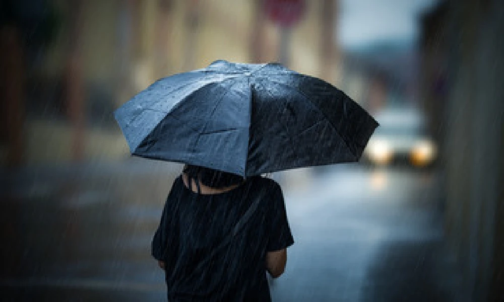Karnataka weather girl walking in rain with umbrala