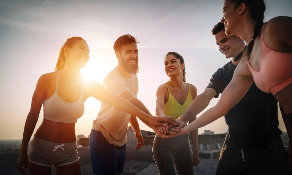 Group of fit healthy friends, people exercising together outdoor
