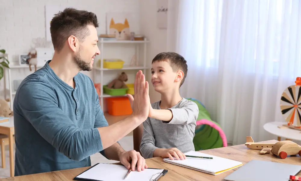 Male Psychologist Working with Little Boy in Office. Autism Concept