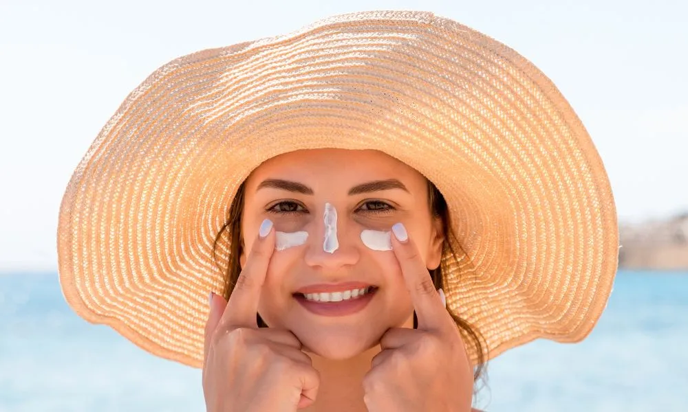 Woman Applying Sunscreen on Face 