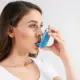 Woman Using an Asthma Inhaler