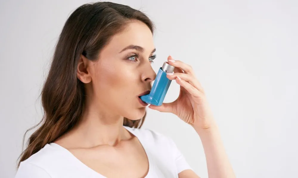Woman Using an Asthma Inhaler