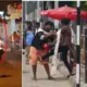 A rider standing on a bike and Young man and woman fight in road