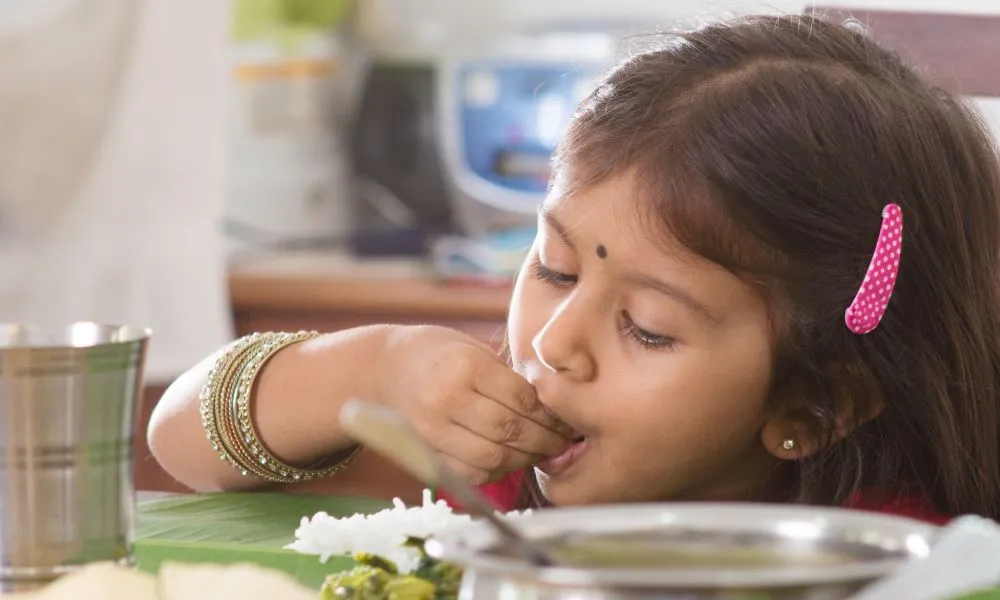Indian girl eating rice