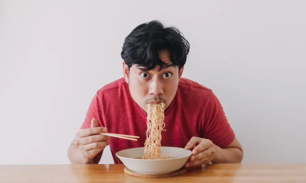 Man Eats Instant Noodles at Home
