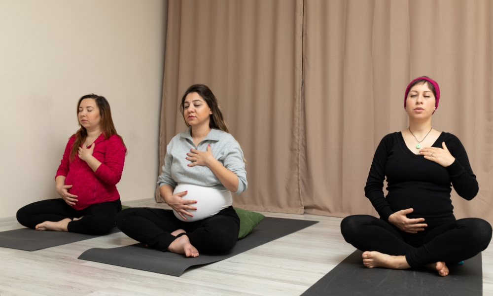 Pregnant young women doing prenatal yoga