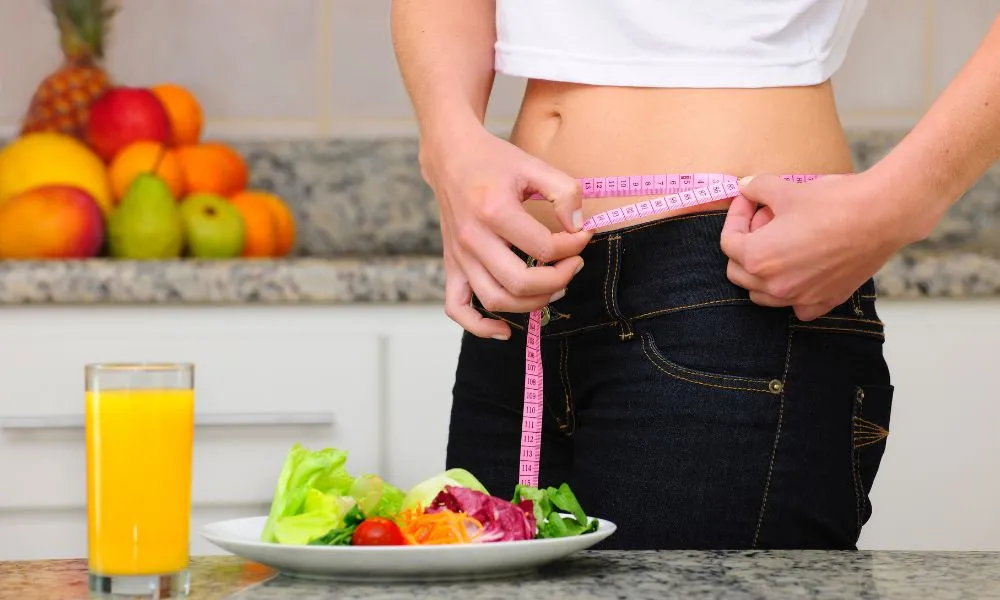 diet woman with salad and measuring tape