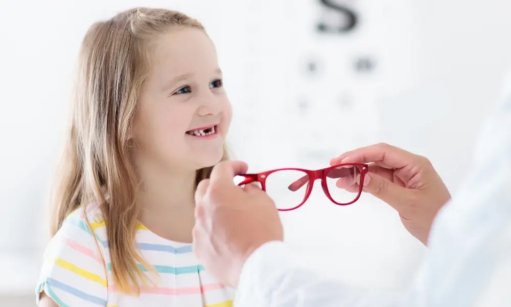 Child at eye sight test. Kid at optitian. Eyewear for kids.