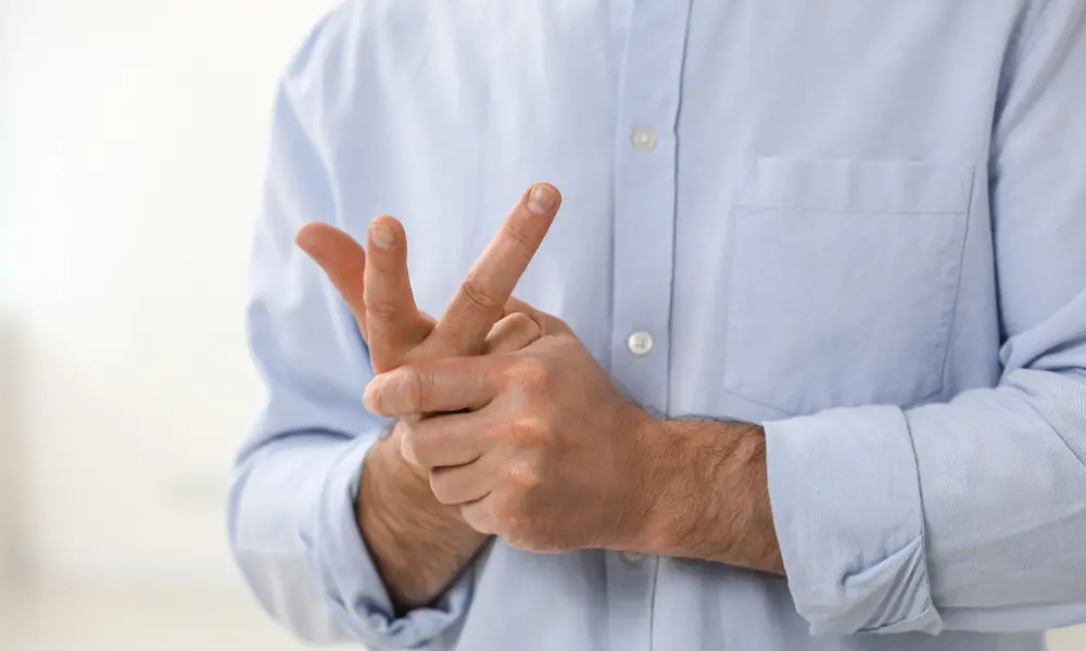 Man Cracking His Knuckles on Blurred Background